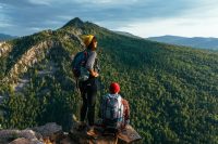 a-man-and-a-woman-with-backpacks-on-the-mountain-admire-the-panoramic-view-hiking.jpg